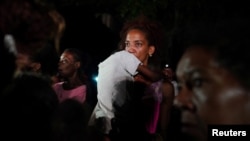 Una madre con su hijo en brazos protesta frente a la sede del Partido Comunista en La Habana, el 29 de septiembre de 2022. (REUTERS/Alexandre Meneghini)