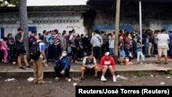 Migrantes de América Central, Haití y Cuba esperan en las afueras de la Comisión de Asistencia para Refugiados Mexicana (COMAR), en Tapachula, en el Sur de México.