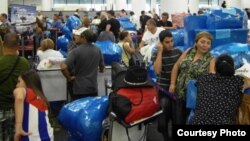 Los cubanos que viajan a Cuba en el aeropuerto de Miami se identifican por su abundante equipaje.