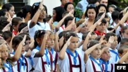 Estudiantes saludan la bandera y cantan el himno nacional