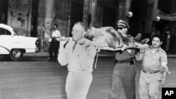 La Cruz Roja transporta a uno de los heridos en el asalto al Palacio Presidencial el 13 de marzo de 1957. AP