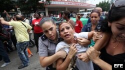 Eralides Frómeta Polanco, de las Damas de Blanco es detenida, entre hostigamiento e insultos de sectores oficialistas, el 10 de diciembre de 2015, en La Habana (Cuba)