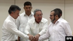 Raul Castro abraza a Juan Manuel Santos y al líder de las FARC, Rodrigo Londoño, alias "Timochenko", tras la firma del acuerdo.