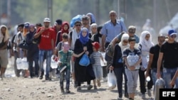 Refugiados cruzan la frontera entre Macedonia y Grecia, cerca de la ciudad de Gevgelija, Macedonia, hoy, 4 de septiembre de 2015.