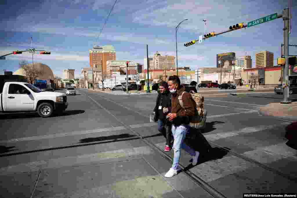 Yunior Espinosa y Pedro Luis Ruiz, migrantes cubanos bajo el Programa de Protección de Migrantes (MPP) por sus siglas en inglés, caminan hacia la terminal de auto bus&nbsp;después de cruzar desde México la frontera hacia El Paso Texas, Estados Unidos y poder continuar sus trámites de asilo. Foto: tomada el 11 de marzo de 2021 por REUTERS/José Luis González.